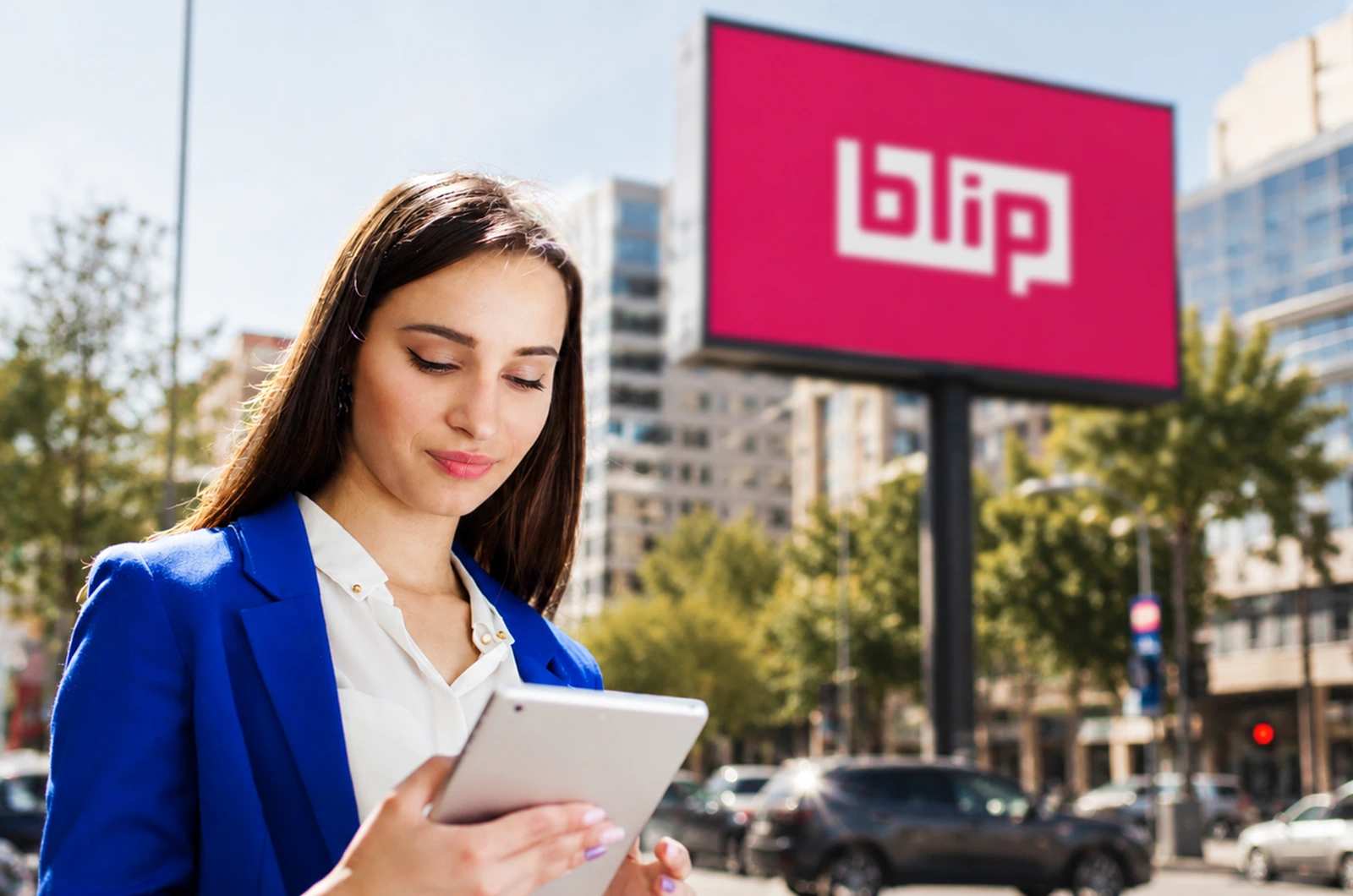 Marketer reviewing campaign data near a Blip billboard