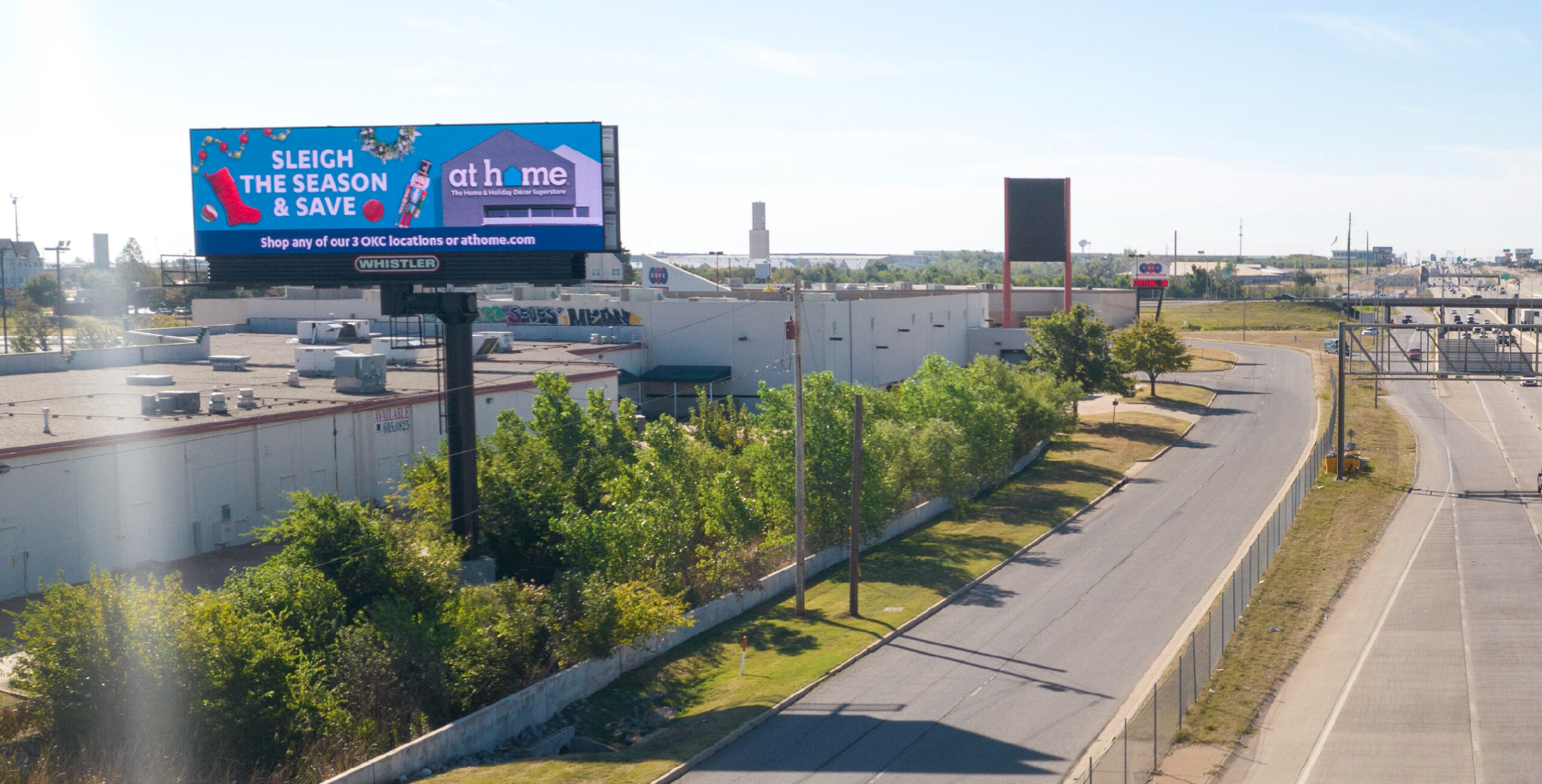 Rooftop digital billboard in sunny cityscape