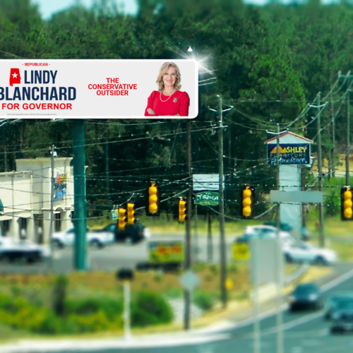 Street intersection with digital billboard and traffic
