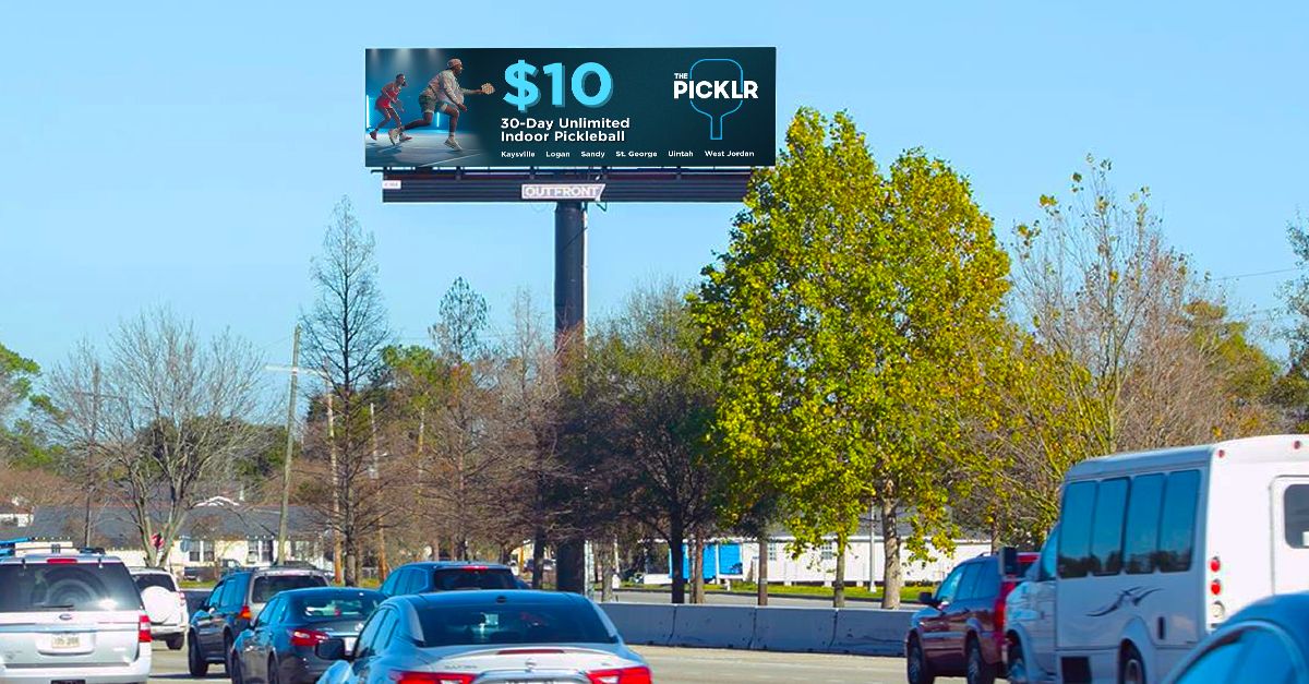 Digital billboard over a highway advertising pickup or delivery deals for $10.
