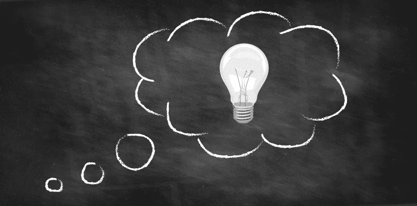 Chalkboard drawing of a lightbulb idea