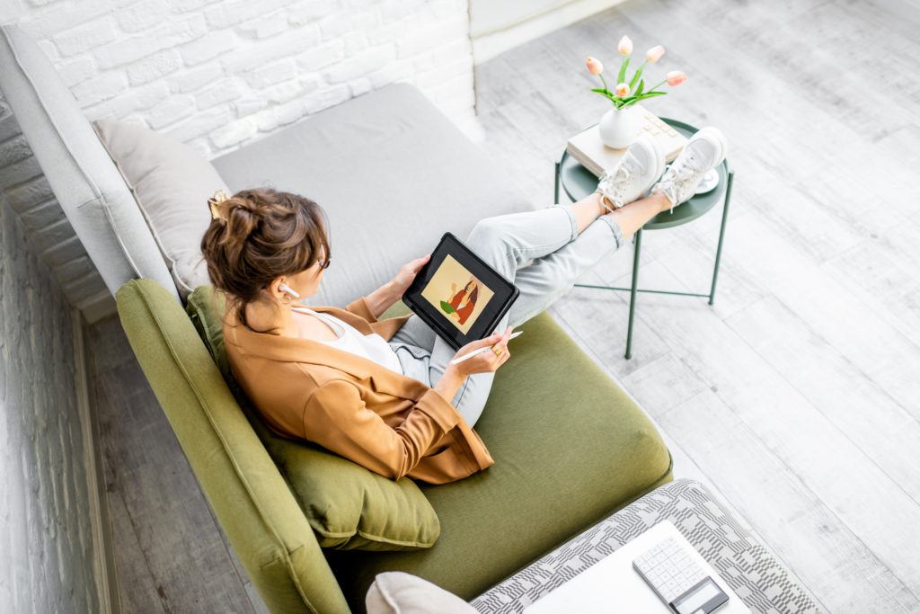 woman drawing on a digital tablet working from homw