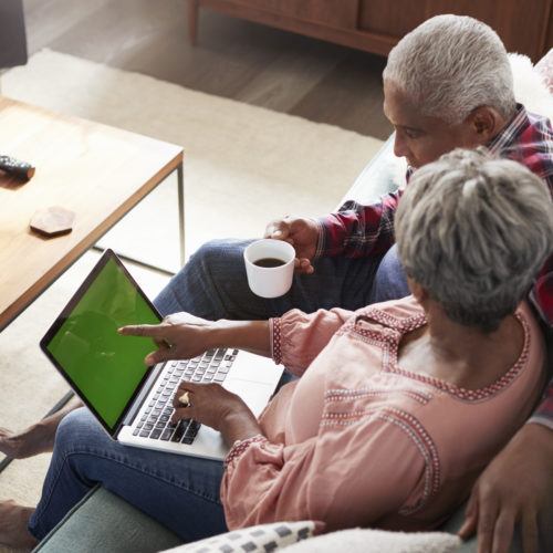 Elderly couple using laptop together