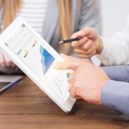 Business team reviewing tablet charts