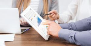 Web Marketing Managers with Gadgets Working