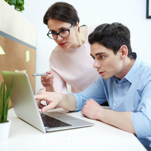 Coworkers collaborating on a laptop