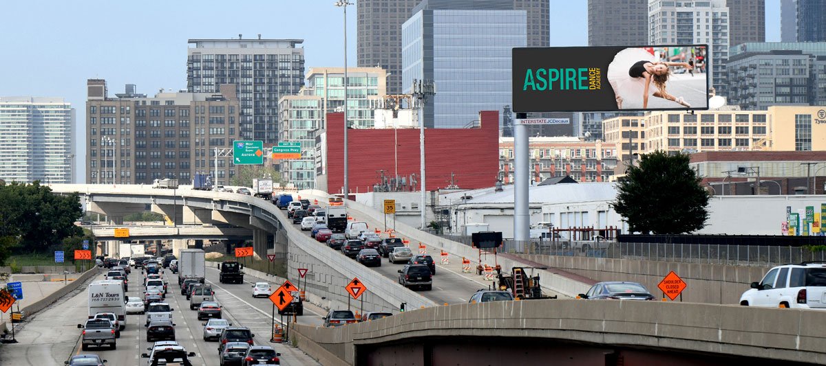 Highway with billboards and city skyline background