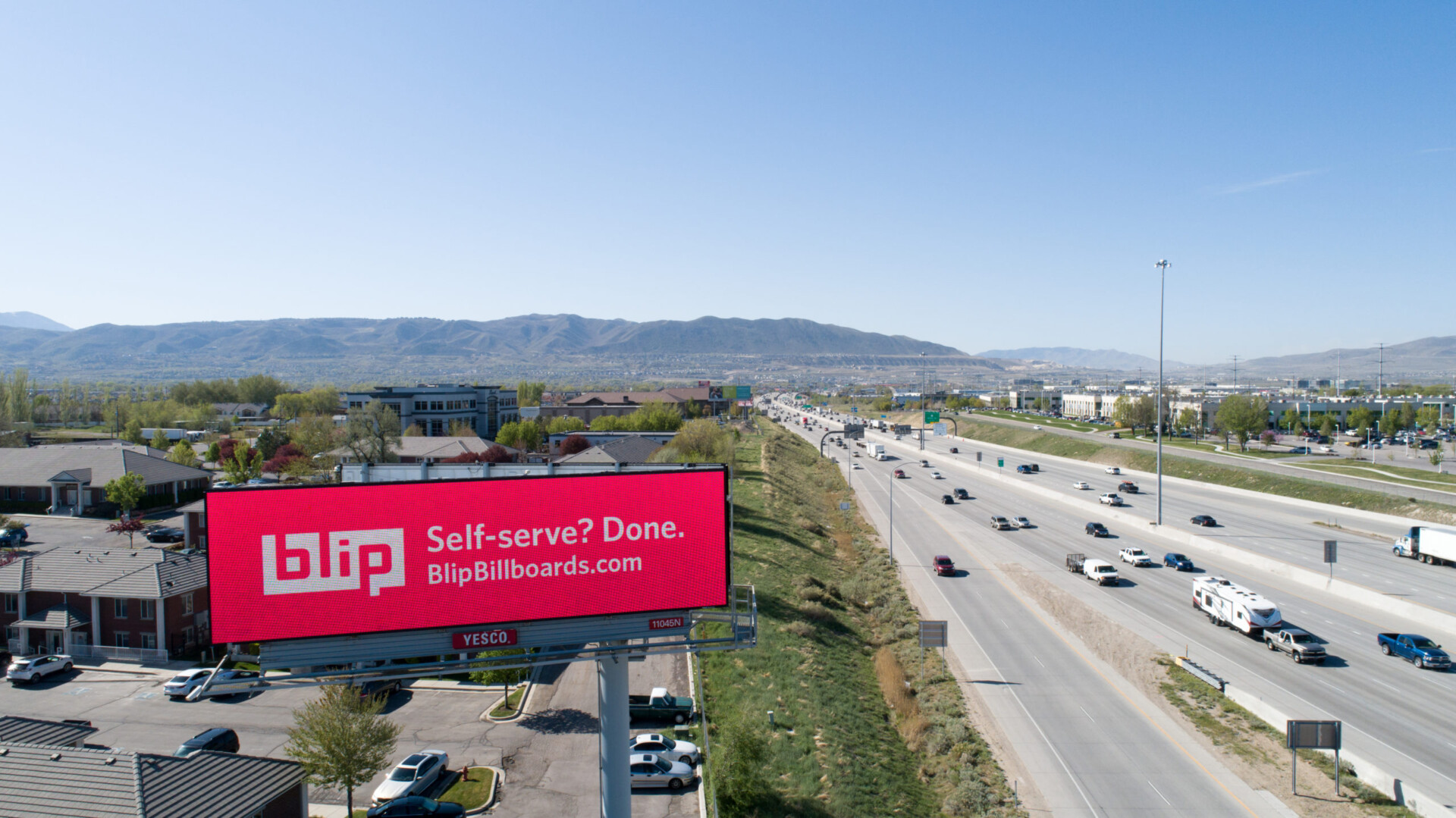 Aerial highway scene with Blip billboard