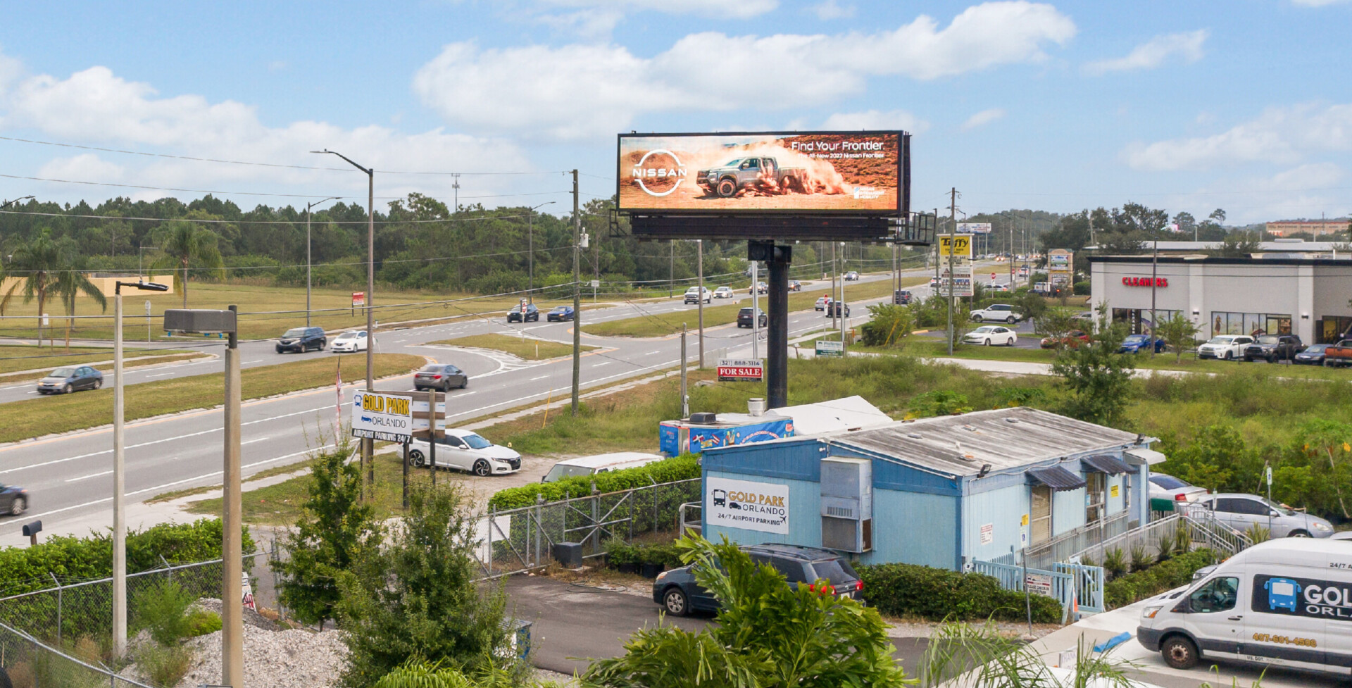 Digital billboard beside highway (daytime view)