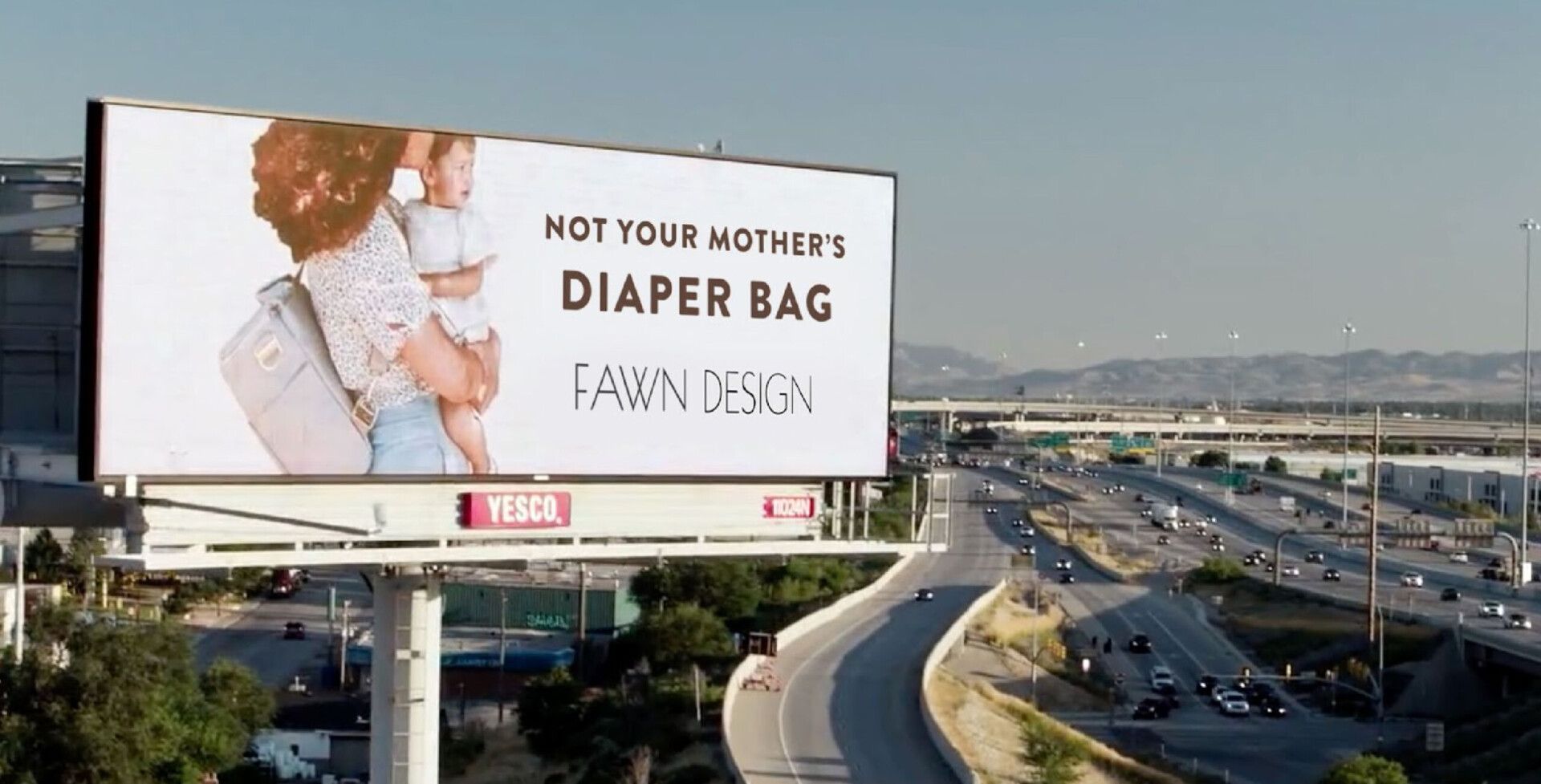 Fawn Design diaper bag billboard on hillside road