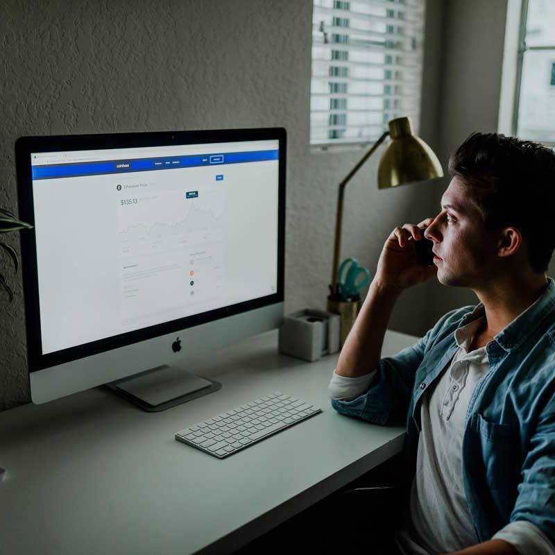 man working on his mac at a desk