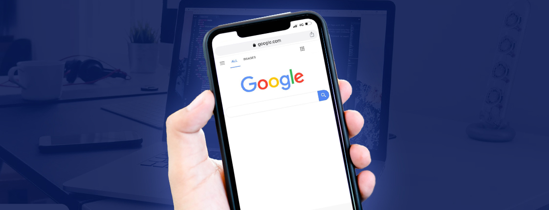 Hand holding phone open to Google search.
