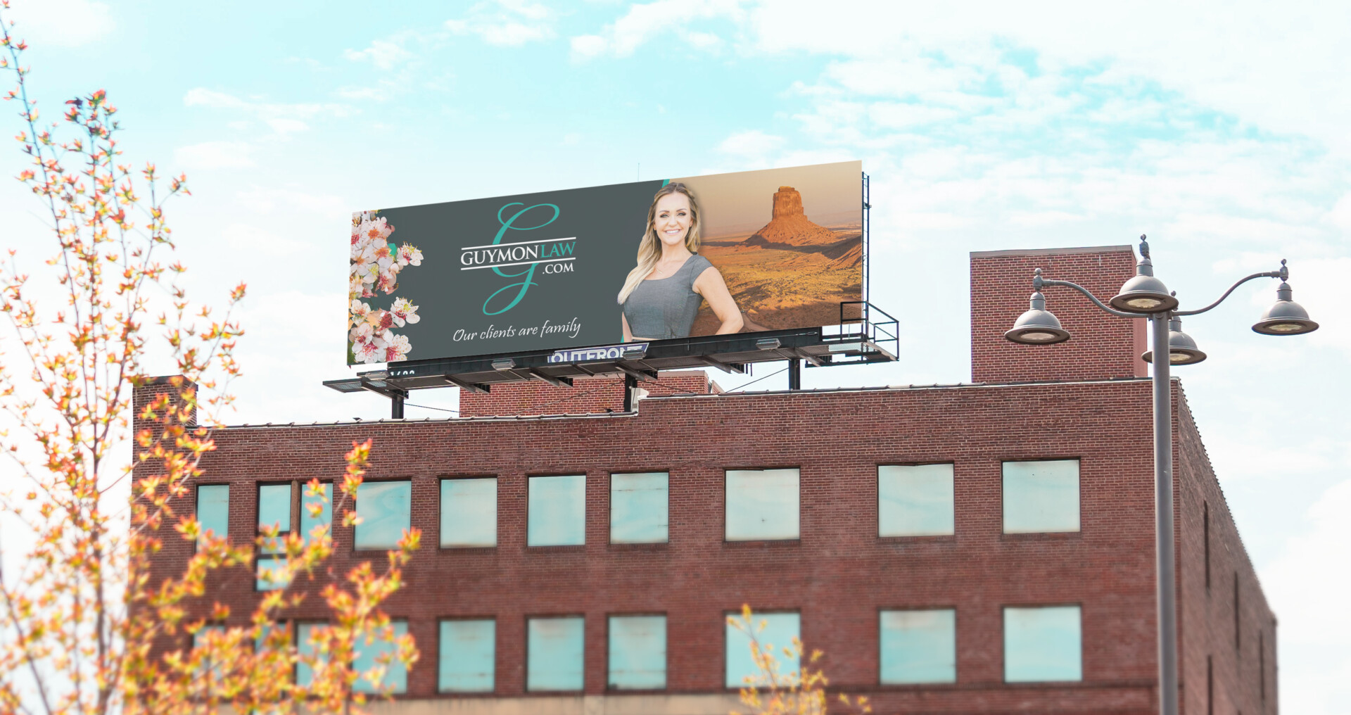 Roadside digital billboard featuring a woman and floral graphics