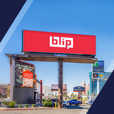 Outdoor billboard with “blip” logo on a roadside sign against blue sky.
